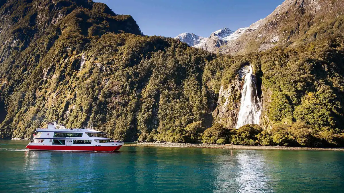 Glass-roof coach on the Milford Road toward a Milford Sound boat tour from Queenstown