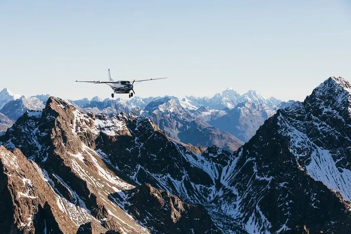 Small plane over snow-capped Southern Alps on a Milford Sound fly and cruise boat tour from Queenstown