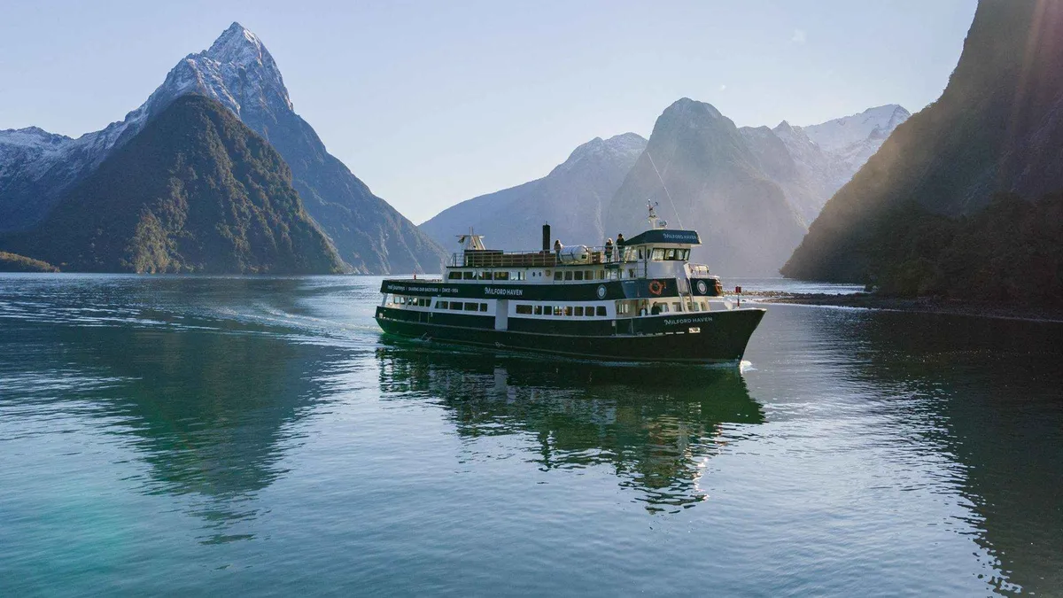 RealNZ vessel in the fiord on a Classic Milford Sound boat tour in Fiordland, New Zealand