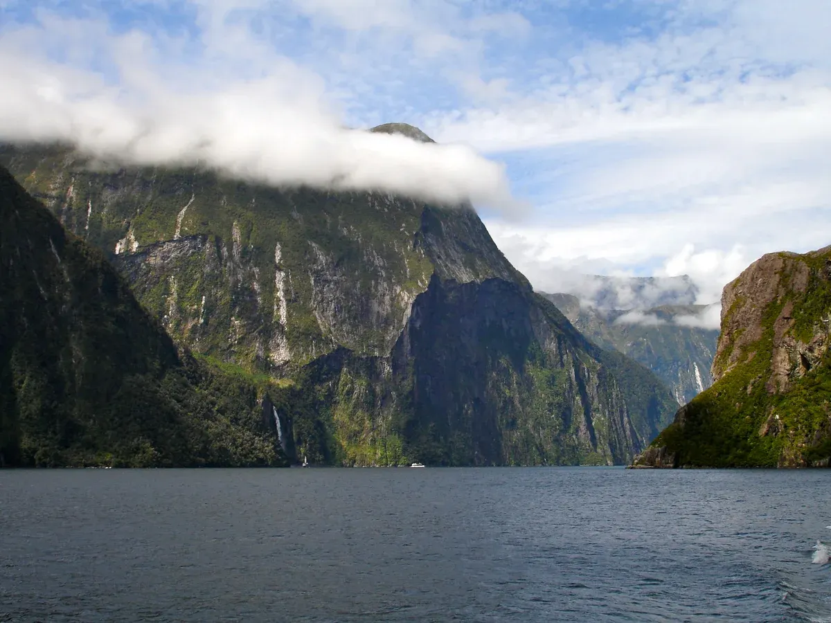 Cloud over the cliffs of Milford Sound seen from the water on a Milford Sound boat cruise