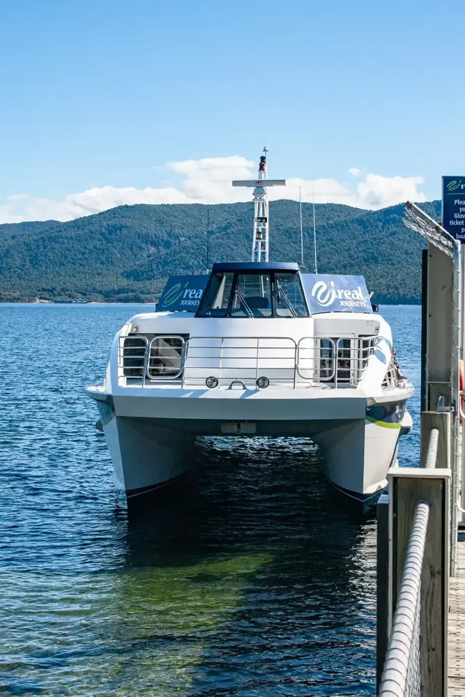 White catamaran moored on Lake Te Anau, near the starting point for Milford Sound cruise days