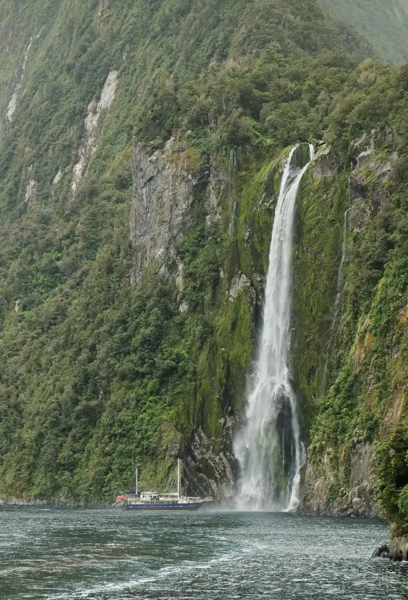 The Milford Wanderer tour boat below Stirling Falls on a Milford Sound boat tour